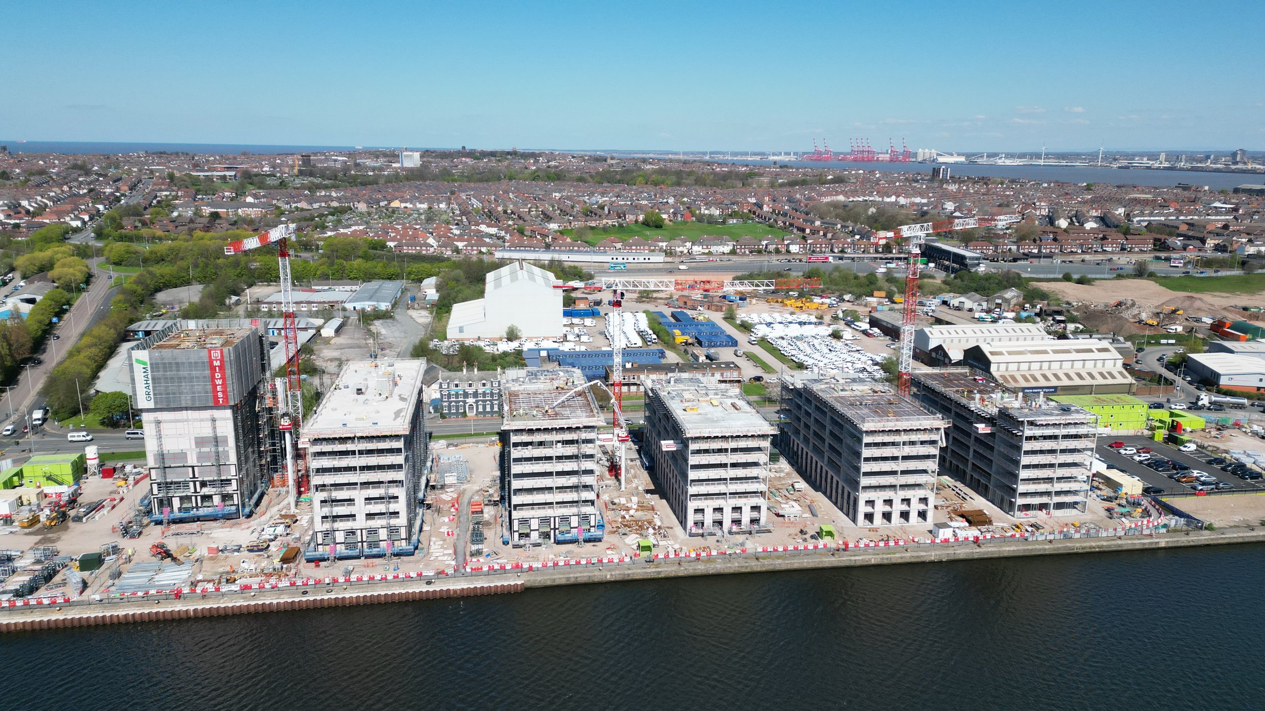Aerial view of Wirral Waters construction site with Midwest tower cranes